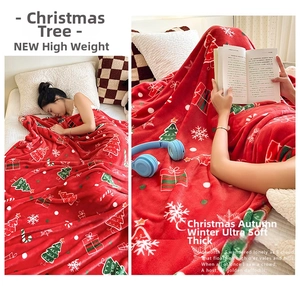 Detail of soft thick flannel Christmas blanket with red festive tree and snowflake patterns