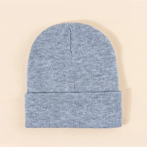 Detailed view of the fine ribbed knit texture and wide folded cuff of a blue beanie