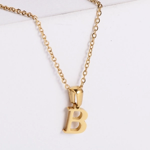 Macro view of gold plated letter B pendant showing polished finish and fine chain detail