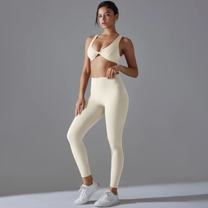 Creamy white yoga set featuring high-waisted leggings and a stylish knot-front sports bra