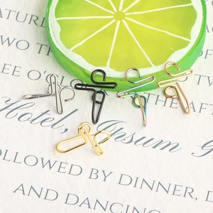 Close-up of five colorful U-shaped non-pierced stainless steel nose clips on creative backdrop