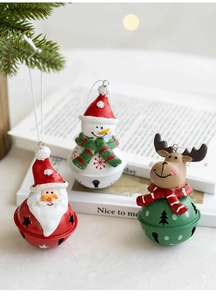 Close-up of Santa Claus and snowman resin pendants on metal Christmas tree bells