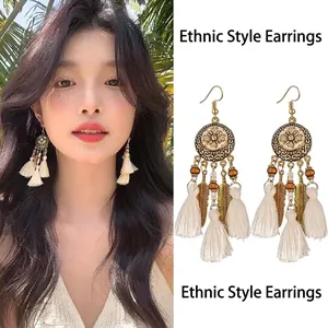 Vintage Bohemian drop earrings with metal leaf charms and long white cotton tassels