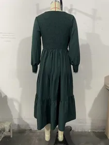 Detail of dark green dress showing elastic ruched back and tiered cake skirt layers
