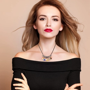 Detail of a 2mm black waxed cord necklace with colorful beads on a professional model