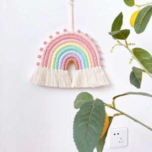 Handwoven rainbow wall hanging with colorful cotton ropes and white tassels for home decor