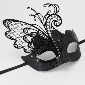 Macro shot of black butterfly masquerade mask with glitter vine patterns and rhinestones