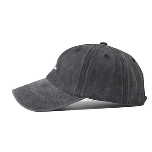 Detailed close-up of white mountain embroidery on charcoal grey washed cotton baseball cap