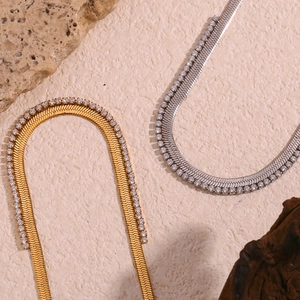 Detail of gold and silver herringbone chains with micro-pave cubic zirconia inlay