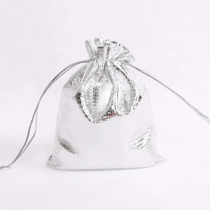 Metallic silver drawstring jewelry gift pouch with a shiny textured finish on white background