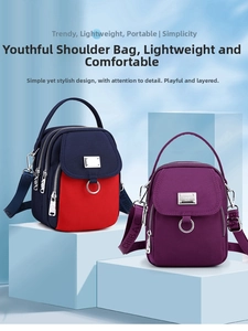Detail of nylon crossbody bags showing multiple zipper compartments and webbing straps