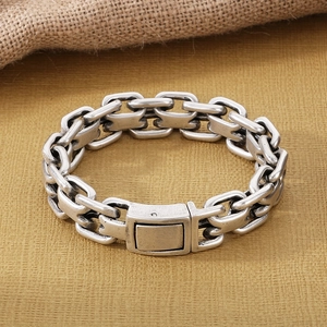 Macro detail of retro silver stainless steel interlocking chain bracelet with clasp