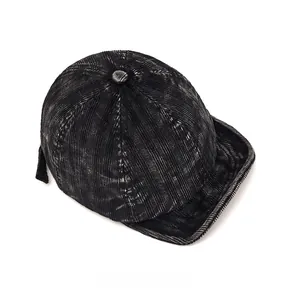 Top view of black corduroy baseball cap showing fine vertical texture and soft short brim