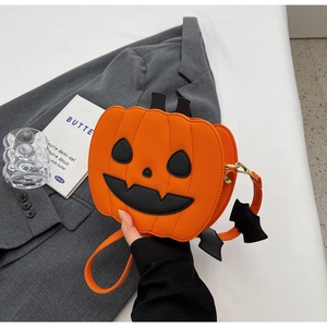 Detail of orange pumpkin bag with black bat wing charms and leather pumpkin texture