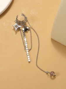 Detail of silver layered chain ear cuff featuring a star pendant and beaded fringe detail