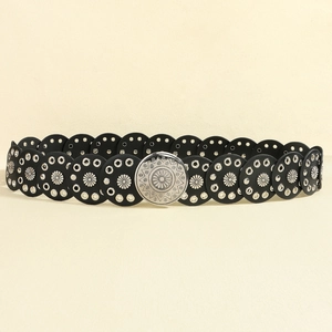 Close-up of black retro Y2K belt with circular leather pieces and floral silver studs