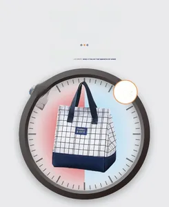 Detail view of plaid lunch bag showing the navy blue strap and thermal insulation layers