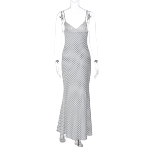 Detailed view of the V-neck and thin spaghetti straps on white polka dot maxi dress