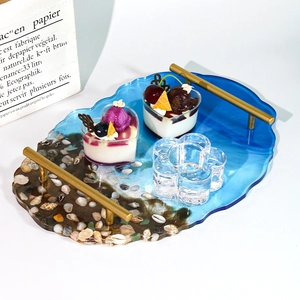 Irregular ocean resin tray with gold handles, seashell decor, and wave edges