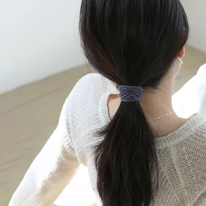 Detail of grey mesh hair tie worn on ponytail with soft cotton blend texture