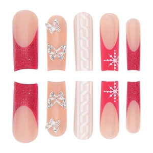 Red French press-on nails with silver butterfly charms and winter snowflake designs