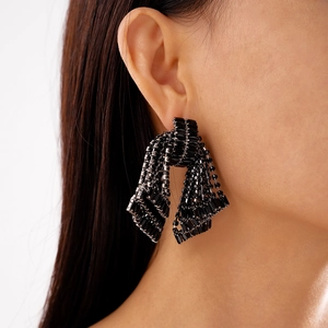 Detail shot of black beaded tassel earrings featuring a tiered cascading fringe design
