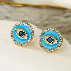 Golden Evil Eye stud earrings with blue enamel and sparkling cubic zirconia halo