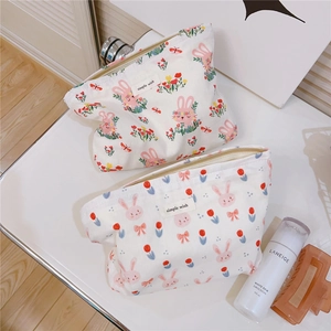 Detailed macro view of two cute rabbit pattern cotton canvas makeup storage pouches