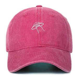 Detail of UFO embroidery and washed vintage texture on this pink cotton baseball cap