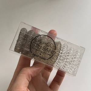 9pcs set of brown TPU spiral hair ties in a clear minimalist storage box with G'S ACC logo
