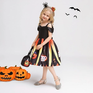 Detail of girl's Halloween pumpkin dress with striped skirt and matching accessories