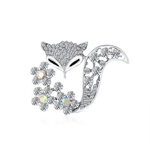 Detail view of silver owl brooch with sparkling crystals and iridescent floral gemstones