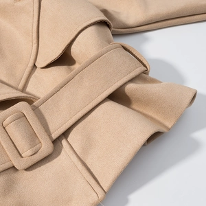 Detail of khaki faux suede jacket waist belt with a matching fabric-wrapped square buckle
