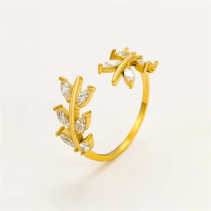 Detailed view of leaf shaped gold plated ring with micro-set zircon stones on white background