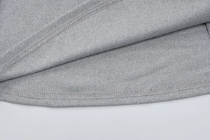 Detailed close-up of gray knitted fabric texture and premium double-needle stitching quality