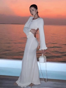 Elegant white open-back long sleeve maxi dress for vacation at seaside sunset beach