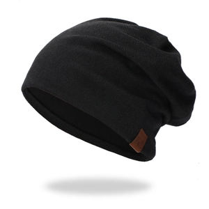 Close-up of the black knit beanie with a brown leather F&S logo tag on side