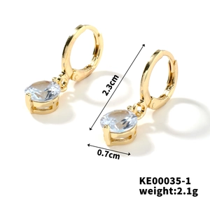 Detail view of gold hoop earrings with zircon stones and dimensions 2.3cm by 0.7cm