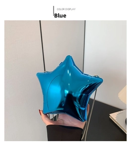 Detail of blue glossy acrylic star-shaped mini clutch with metal chain strap