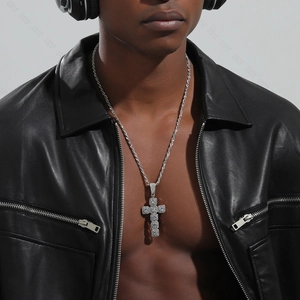 Silver cross pendant necklace with micro-pave zircons worn by a male model in a black jacket
