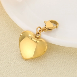 Detailed macro view of a gold-plated heart pendant featuring a lobster clasp closure