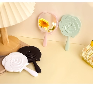 Detail showing various colors of elegant 3D rose flower shaped handheld makeup mirrors