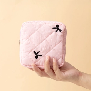 Pink quilted pouch with black bow embroidery for sanitary pads and small accessories