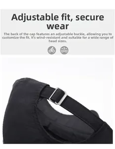Detailed close-up of the adjustable metal buckle and textured fabric on the black baseball cap