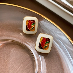 Detail of vintage square enamel earrings with oil painting pattern on silk background