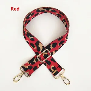 Adjustable leopard print bag strap in red and black with gold metal hooks
