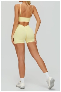 Detail view of seamless pale yellow sports set with double strap bra and V-shape gym shorts