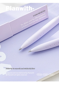 Close-up of 0.5mm 3-color gel pen with a matte lavender barrel on a notebook
