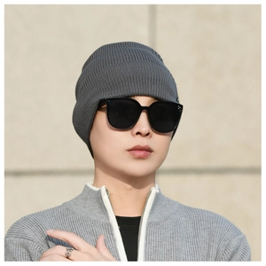 Detailed close-up of grey ribbed knit beanie with soft texture and thick elastic weave
