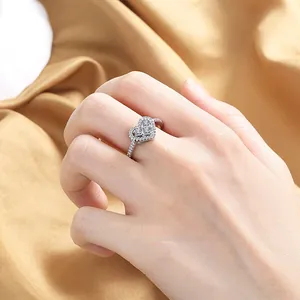 Detailed view of silver heart ring with pavé-set zircons on gold satin fabric